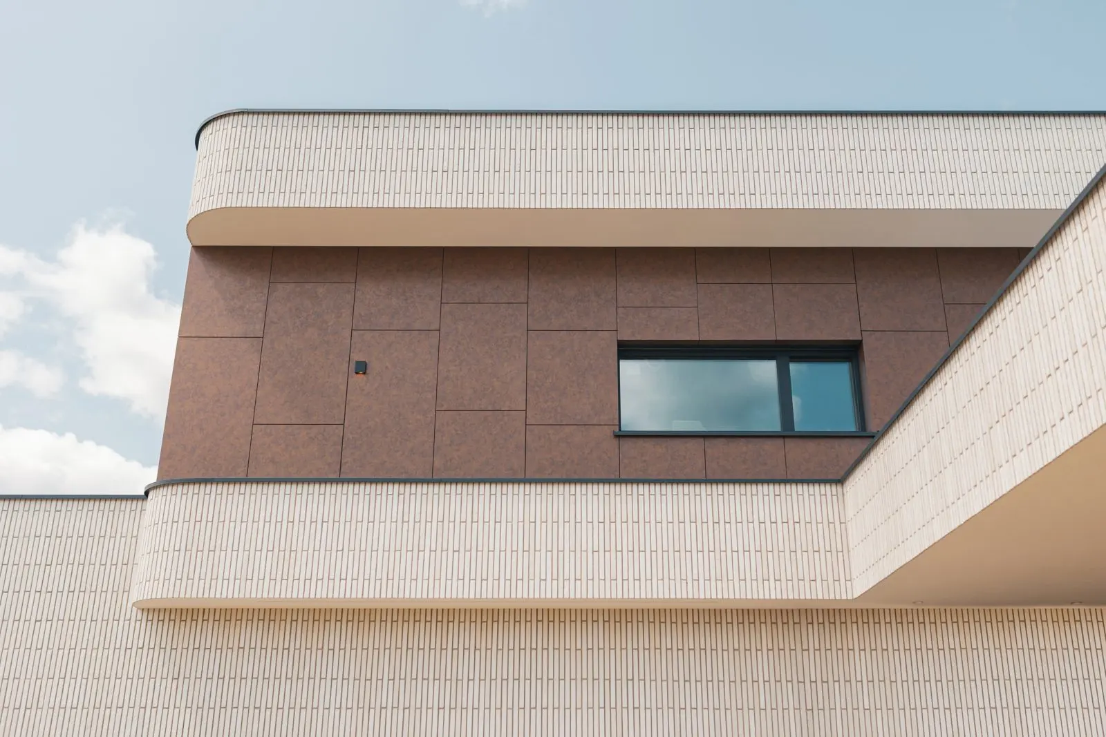 Inspiration, European project overseas: tall aluminum window in a plaster facade