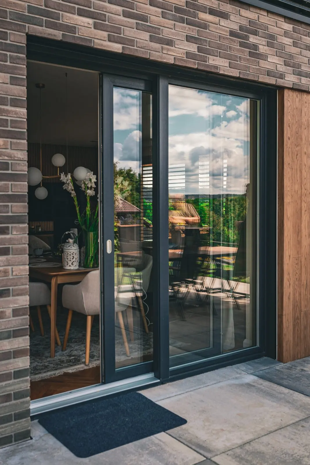 Inspiration, European project overseas: dark-framed sliding glass in brick