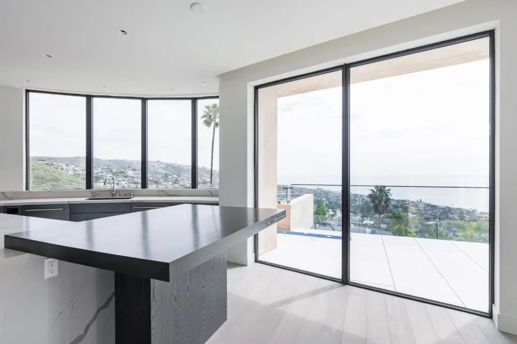 Kitchen with dark-framed sliding doors onto a terrace