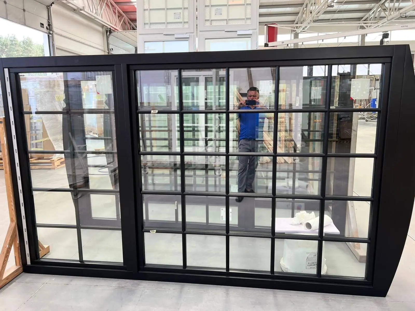 Black steel-look aluminum windows with divided lites before shipping