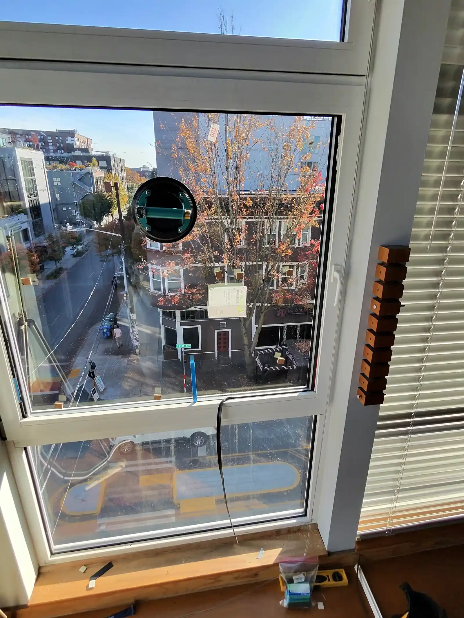Glass replacement on a European window with plastic glazing shims and a level on the sill