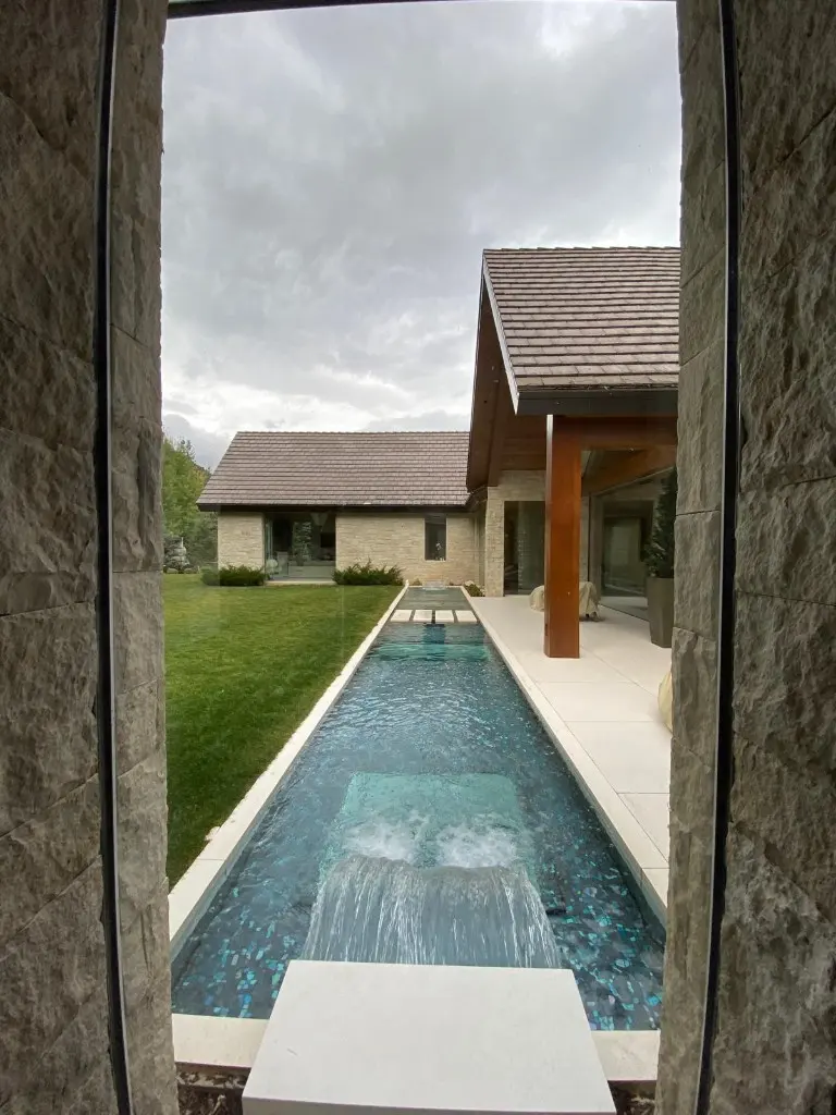Water feature between stone walls, looking back toward the house
