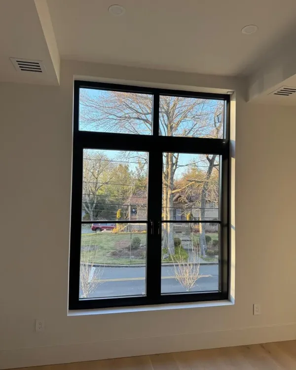 Pair of tilt-and-turn windows being checked in a Seattle home