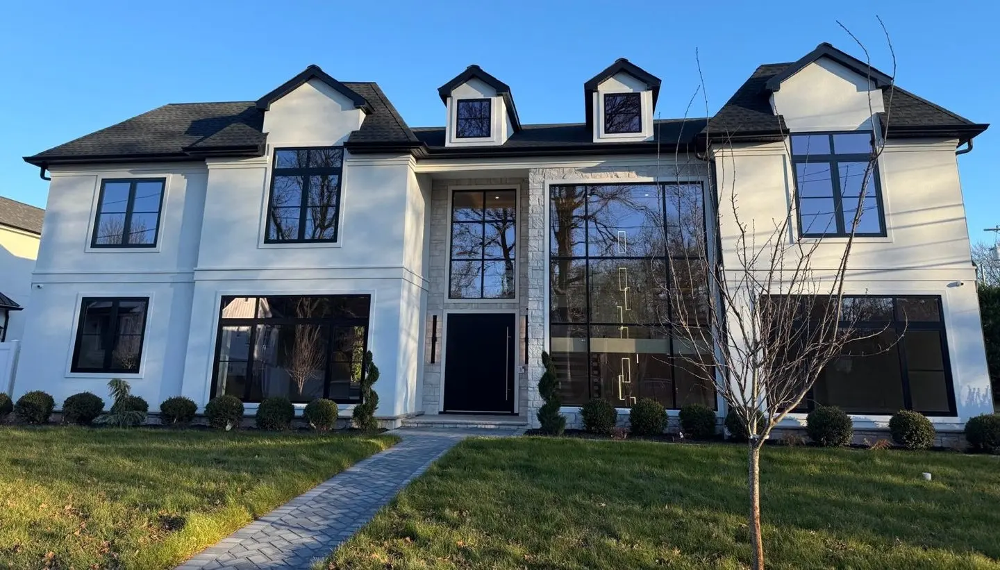 Seattle install: white two-story house with black-framed European windows