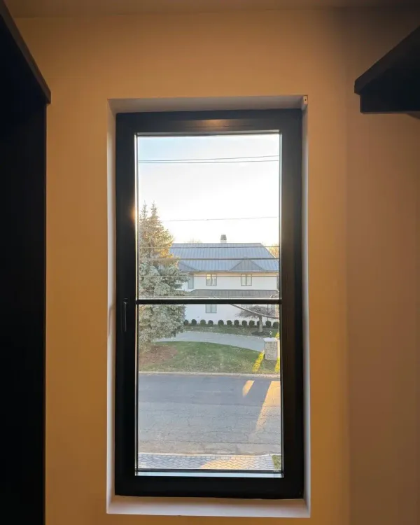 Tilt-and-turn sash edge showing hardware strip and locking cam
