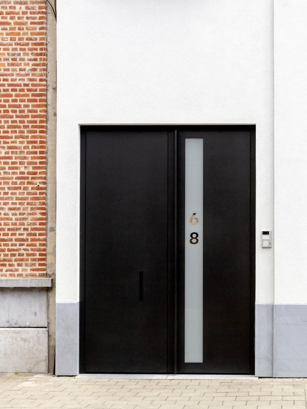 Aluminum entry door, black, with a tall glass sidelight panel