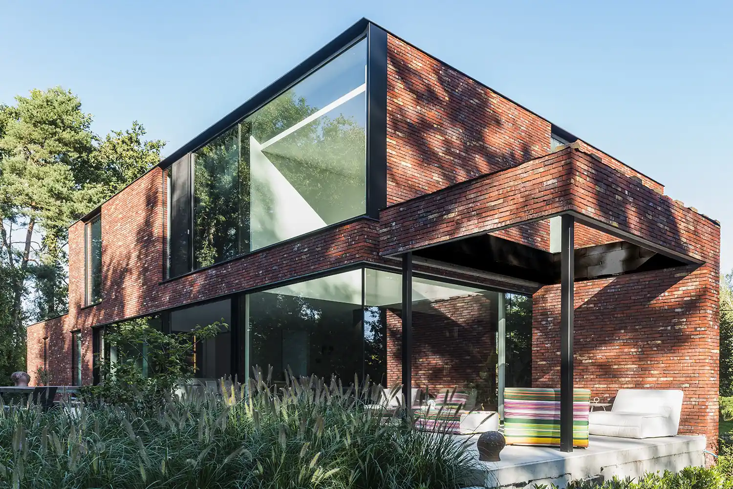 MasterLine 8 Elite aluminum windows, dark frames, on a modern brick house