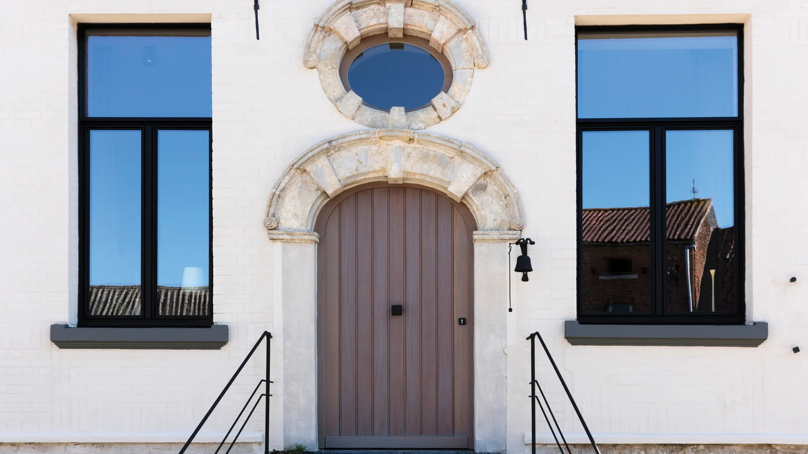 SlimLine Elite aluminum windows, black slim frames, in a white traditional facade