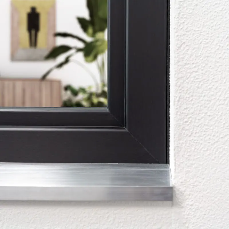 Dark-colored uPVC window frame and sill detail